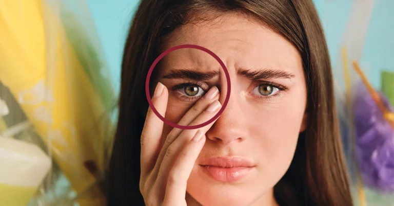 Woman rubbing eye, highlighting eye irritation.