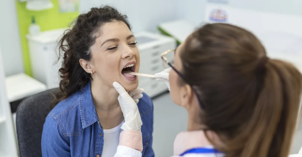 female-patient-opening-her-mouth-doctor